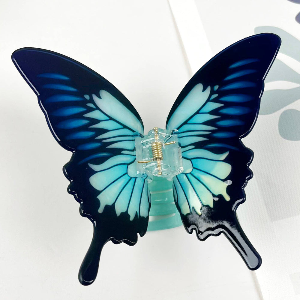 Butterfly-shaped hair clip on a white background